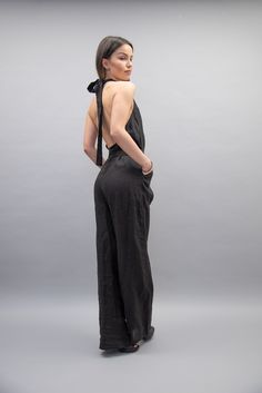 "Open back, long legged with overlapping front, this classic jumpsuit is made of fine linen and with its simple silhouette is perfect to match with any shoes and accessories. Graceful, delicate or casual and smooth, you can make sure this garment will fit any mood or style. MATERIALS: × Linen ---------------------------------------------------------- If you have any questions about the item or have any personal requirements about the garment, please do not hesitate to send us a message, our team Black Halter Neck Jumpsuit For Work, Black Summer Overalls For Workwear, Black Summer Workwear Overalls, Black Backless Jumpsuits And Rompers For Spring, Backless Black Jumpsuits And Rompers For Spring, Black Backless Jumpsuit For Spring, Black Halter Neck Jumpsuit For Night Out, Black Fitted Sleeveless Overalls, Chic Fitted Black Overalls