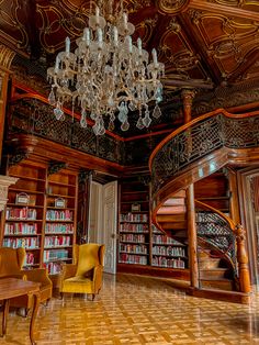 an ornate library with chandelier, chairs and bookshelves filled with books