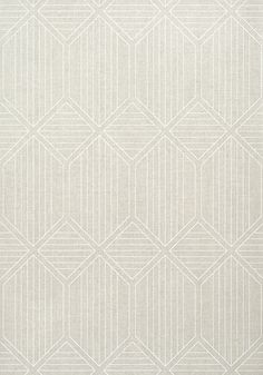 a white rug with an abstract design on the front and back side, in shades of beige