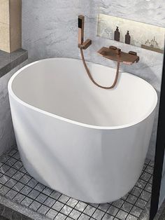 a large white bath tub sitting on top of a tiled floor