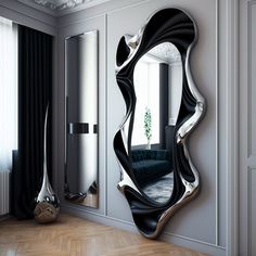 a large mirror sitting on top of a wooden floor next to a couch in a living room