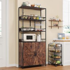 a kitchen area with a microwave, cabinets and shelves on the wall next to a hardwood floor