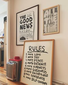 two framed posters on the wall above a wooden floor