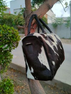 Black & white cowhide shoulder bag for daily use. Embrace western & southern style. Perfect for work, carry your daily essentials. - Free shipping on all our cowhide shoulder bags. - Exotic hair-on-hide material. - Adjustable leather strap for customizable comfort. - Interior features cotton/satin lining with 2 inside pockets and one zipper pocket. - Structured handbag crafted with exquisite craftsmanship. - Measurements: Height: 10 inches X Length: 12 inches X Depth: 6 inches - Please note: Pictures are for illustration purposes only. - Each cowhide purse takes approximately seven business days to complete. This cow skin shoulder bag is skillfully made from high-quality cowhide leather, featuring a captivating combination of black and white hues that exude both sophistication and practica Exotic Hair, Exotic Hairstyles, Cowhide Purse, Cowhide Bag, Note Pictures, Fur Bag, White Cow, Cow Skin, Cow Hide