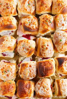 many different types of food are arranged on a sheet of baking bread with cheese and meat