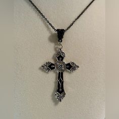 Unisex Women Men Black And Silver Tone Cross Pendant Necklace. Lovely Black And Silver Tone Cross Pendant On A Black Necklace, Perfect Addition To Your Necklace Collection. Looks Great With Simple Or Fancy Outfits. *Brand New. *Necklace Length: 50cm. *Necklace Material: Stainless Steel. *Necklace Color: Black. *Cross Size: 5.5cm X 3.7cm. *Cross Material : Zinc Alloy. *Will Ship Next Day Or Same Day If Possible. *Make A Bundle Of 2 Or More Items And Save $2 (Message Me First!) #Gothicnecklace#Rel Necklaces With Crosses, Black Metal Cross Necklace As Gift, Elegant Black Cross Necklace Gift, Black Sterling Silver Cross Necklace For Gift, Cross Gothic, Black Sterling Silver Cross Necklace, Black Cross Pendant Jewelry With Silver Chain, Gothic Black Cross Necklace Gift, Gothic Black Necklace With Silver Chain