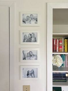 a white book shelf with pictures on the wall and bookshelves in front of it