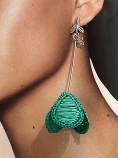 Intricately crafted, these Emerald Flower Shape Raffia Earrings are a delightful addition to any jewelry collection. The vibrant green color of the raffia material is eye-catching and unique, while the intricate flower shape design adds a touch of elegance. The lightweight nature of these earrings makes them comfortable to wear all day long, while still making a bold fashion statement. Perfect for adding a pop of color to any outfit, these earrings are versatile enough to be worn with casual or Elegant Woven Earrings For Spring, Unique Handwoven Green Earrings, Elegant Woven Dangle Jewelry, Green Flower Shape Earrings For Spring, Bohemian Green Flower Earrings For Party, Green Flower Earrings For Spring, Green Dangle Earrings For Spring, Elegant Woven Earrings For Party, Green Flower Earrings For Party