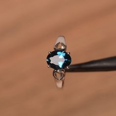 It is London blue topaz ring, the main stone is about 7mm*9mm, oval cut, weight about 2.18 carats.The basic metal is sterling silver and plated with rhodium.To change the metal to a solid gold (white/rose) or platinum is also available, please ask for a quotation if you want.You can also go to my shop Home for more elegant rings: https://www.etsy.com/shop/godjewelry?ref=hdr_shop_menuMore London blue topaz rings:https://www.etsy.com/shop/godjewelry?ref=seller-platform-mcnav&section_id=2071503 Topaz Solitaire Birthstone Ring Oval, Oval Topaz Birthstone Ring In Sterling Silver, Oval Topaz Solitaire Birthstone Ring, Oval Solitaire Topaz Birthstone Ring, Sapphire Colored Topaz Oval Promise Ring, Sapphire Topaz Solitaire Ring, Oval Cut, Blue Topaz Oval Ring For Promise, Oval Blue Topaz Promise Ring, Oval Topaz Rings With Vs Clarity