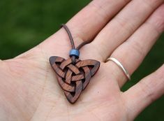 "This beautiful and unique hand-carved Triquetra pendant will be made for you, or a loved one, in my studio on the West of Ireland. This delicately carved Celtic knot features a piece of rosewood, recycled from musical instruments constructed by a local luthier. As a musician myself, I take enormous satisfaction in creating a piece of jewellery whose inherent wood has previously featured in a beautiful hand-made guitar! Celtic knots date back to the 3rd to 4th century B.C. They were used to symb Symbolic Carved Brown Jewelry, Brown Carved Spiritual Jewelry, Spiritual Brown Carved Jewelry, Traditional Mahogany Jewelry As Gift, Traditional Mahogany Jewelry For Gifts, Traditional Handmade Mahogany Jewelry, Triquetra Pendant, Jewelry For Him, 5 Year Anniversary Gift