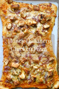 a pizza sitting on top of a pan covered in cheese and toppings with the words honey habanero chicken pizza