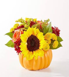 a vase filled with lots of flowers sitting on top of a table