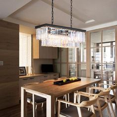 a dining room table with chairs and a chandelier hanging from it's ceiling