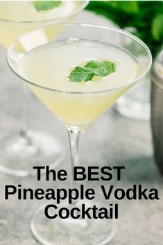 the best pineapple vodka cocktail in a martini glass with mint garnish on top