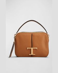 Tod's crossbody bag in leather, cotton, and linen     Top handle     Detachable, adjustable crossbody strap    Can be worn as a top handle or crossbody bag     Double zip top closure     Exterior, back slip pocket and signature T accent     Approx. 4.7"H x 8.4"W x 2.7"D    Made in Italy Designer Tan Crossbody Bag, Modern Tan Satchel Shoulder Bag, Designer Tan Top Handle Shoulder Bag, Modern Tan Shoulder Bag, Tan Satchel Shoulder Bag With Gold-tone Hardware, Modern Tan Shoulder Bag With Detachable Handle, Tan Crossbody Shoulder Bag With Detachable Strap, Tan Crossbody Shoulder Bag With Adjustable Strap, Modern Tan Shoulder Bag With Adjustable Strap