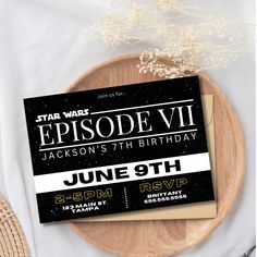 a star wars birthday party card on a wooden plate