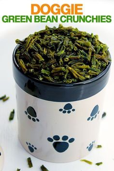 a cup filled with green bean crunches on top of a table