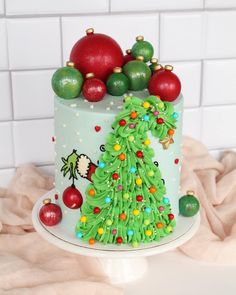 a decorated christmas cake with ornaments on top