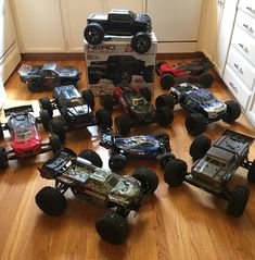 a group of toy cars sitting on top of a wooden floor