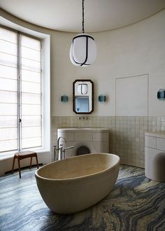 a large bath tub sitting in the middle of a bathroom