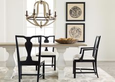 a dining room table with four chairs around it