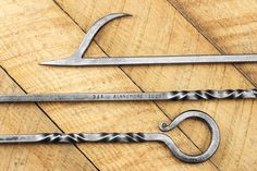 two wrenches are sitting on top of a wooden table next to a pair of scissors