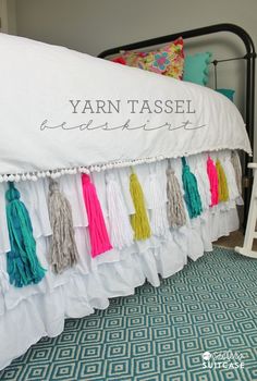 a bed with tassels hanging from it's sides and the words yarn tassel on top