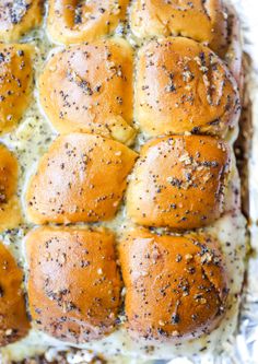 hot cross buns with cheese and seasoning sprinkled on top in a baking pan