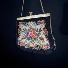 A small ladies handbag vintage handmade. Fine example of a cosy lady's handbag of the beginning of the last century. Hand embroidered fabric. Metal clasp and black satin inside. Look at those small representations of flowers on the front and back of the bag. Lovingly made. Vintage. Size  W 18 H 17 cm. It has been around for a long time but just a tiny bit of wear. Still beautiful and surely wearable. Please have a look at all our vintage handbags in the  - Ladies Handbags - or the - Ladies first Vintage Formal Bag With Floral Embroidery, Vintage Floral Embroidery Bags For Formal Occasions, Vintage Floral Embroidered Bag For Formal Occasions, Vintage Floral Embroidery Formal Bags, Vintage Embroidered Clutch Evening Bag, Formal Embroidered Tapestry Bag, Handmade Tapestry Bags For Evening, Antique Tapestry Evening Bag, Handmade Tapestry Evening Bags