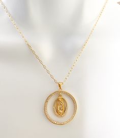 Our lady of Guadalupe necklace Beautiful and dainty 18k Gold Plated Guadalupe necklace. Perfect gift for moms, grandmas, aunts, sisters and why not yourself?! MATERIAL AND SIZE 18k gold plated medal 18k gold filled cable chain Cubic zirconia Size pendant: 2.4cm Length chain: you choose it If you have questions about the product, feel free to reach me out. Don't forget to check out my other items in the store: Https://www.etsy.com/shop/nyahwithlove Spiritual Jewelry: Our Lady Of Guadalupe Round Pendant, Gold Our Lady Of Guadalupe Round Pendant Necklace, Spiritual Yellow Gold Our Lady Of Guadalupe Jewelry, Gold Virgin Mary Medallion Jewelry, Miraculous Medal Pendant Jewelry For Wedding, Miraculous Medal Wedding Pendant Jewelry, Wedding Miraculous Medal Pendant Jewelry, Lady Of Guadalupe Necklace, Scapular Necklace