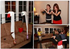 two women playing wii in a living room with other people watching and drinking beverages on the couch