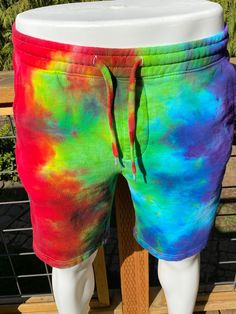 Ice tie dye small sized unisex shorts. These shorts are pull on, have a elastic waist and a shoestring drawcord. Has 2 side pockets and one in the rear! No fly opening, just pull it off when needed! These are fleece lined shorts, sweatshirt material. The side pockets are jersey lined, tapered knee opening. 80% cotton and 20% poly, easy machine wash and dry with dark colors and machine dry. Measurements are garment laid out flat 15 inches from waist edge to edge 18 1/2 inches from top of waist to Multicolor Relaxed Fit Bottoms With Drawstring, Casual Festival Shorts, Casual Multicolor Shorts For Festival, Casual Multicolor Festival Shorts, Tie Dye Cotton Bottoms Short Length, Casual Tie Dye Shorts With Elastic Waistband, Tie Dye Cotton Short Length Bottoms, Spring Tie Dye Shorts With Elastic Waistband, Casual Tie-dye Short Bottoms