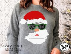 a woman wearing a santa clause sweatshirt with sunglasses on her face and the words hello home