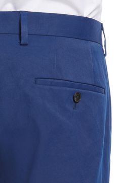 Crisp, classic and versatile, these staple flat-front chinos sport a handsomely tailored fit and a creased finish that keep them smart styled up or down. 14" leg opening; 10" front rise; 15" back rise (size 32) Zip fly with hook-and-bar closure Front slant pockets; back button-welt pockets Partially lined Unhemmed. Get the perfect fit—book an appointment with one of our alterations experts 100% polyester Dry clean Made in Turkey Men's Clothing Fitted Solid Color Chinos With Welt Pockets, Formal Spring Flat Front Chinos, Classic Flat Front Chinos With Belt Loops, Classic Solid Color Chinos For Business Casual, Business Casual Chinos With Welt Pockets And Flat Front, Workwear Chinos With Pressed Crease, Tailored Formal Chino Cotton Twill Chinos, Classic Tailored Chinos With Straight Hem, Classic Chinos With Pressed Crease And Straight Hem