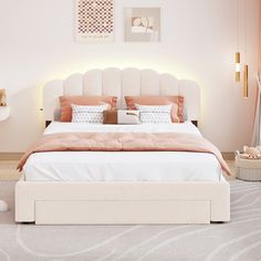 a white bed with orange pillows in a bedroom