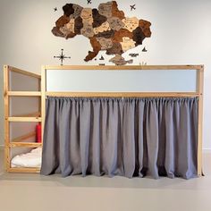 a bunk bed with curtains and a map on the wall