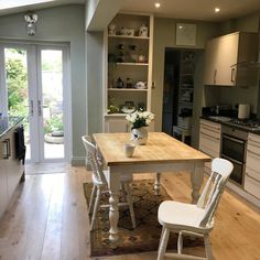 a kitchen with a table and chairs in it