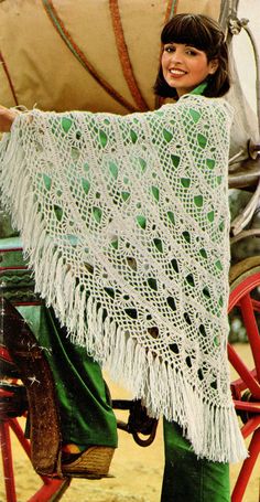 a woman is holding up a crocheted shawl on a cart with the words snowdrop shawl in it