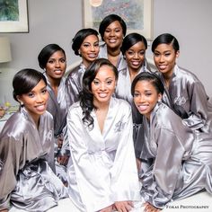 a group of women in silver robes posing for a photo