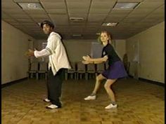 two people are dancing in an empty room