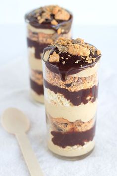 two desserts are sitting on a table with a sign that says butterfingerer chocolate holiday trifles