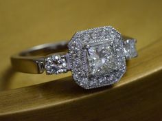 a diamond ring sitting on top of a wooden table