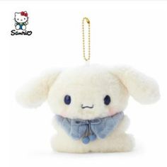 a white stuffed animal with a blue bow tie on it's neck and eyes