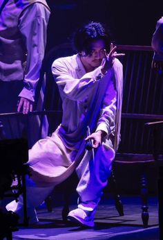 a man is kneeling down on the stage