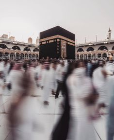 blurry image of people walking in front of a large building with a black dome