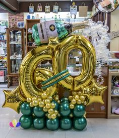 an inflatable balloon shaped like the number 20 with balloons attached to it and some other items