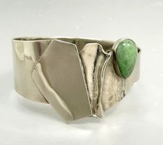 "Asymmetric Avi Soffer Sterling 925 Bangle Bracelet Modernist Jewelry Israeli Jewelry Artist, Avi Soffer, Majestic Sterling Silver 925 Bangle Bracelet Adorned With A Green Aventurine Cabochon Modernist , Brutalist Design The Face Measures 1,5\" At The Highest Point 3/4\" The Lowest Point Tapering To The Back Of 7/8\" The Bracelet Is Created In A Brilliant Finish With The Crinkle Front Area In A Matte Finish 49.2 Grams 2 3/8 x 2 5/8\" Diameter 7.5\" Circumference jujubee1.etsy.com To Browse My Sh Playful Jewelry, Brutalist Design, Gemstone Art, Jewelry Artist, Turquoise Pendant Necklace, Modernist Jewelry, Gold Cross Pendant, Online Gift, Modern Ring