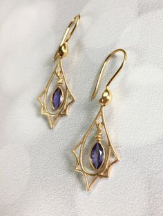 "Art Deco lovers here are purple Amethyst and gold earrings! So often we see Art Deco designs that are only red and gold but I also make Art Deco with many gemstones. These sweet earrings are lightweight and easy to wear. The faceted Amethyst stones are set in Vermeil gold that dangle freely within a Vermeil gold Art Deco charm that has a soft brushed finish. They hang 1.5 inches on Vermeil gold ear wires with a gold accent. These also make a wonderful gift for someone born in February since Ame Art Deco Gemstone Earrings For Gift, Art Deco Pierced Jewelry For Anniversary, Art Deco Faceted Jewelry For Formal Occasions, Art Deco Faceted Jewelry For Wedding, Art Deco Amethyst Jewelry Gift, Art Deco Teardrop Jewelry Gift, Art Nouveau Jewelry With Matching Earrings For Wedding, Art Nouveau Wedding Jewelry With Matching Earrings, Art Deco Amethyst Jewelry In Yellow Gold