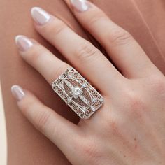 This exquisite Art Deco platinum and 18kt. yellow gold ring features a stunning 0.78ct transitional diamond at its center surrounded by 18 Old European Cut diamonds totaling 0.48ct. The ring has been expertly crafted to repurpose a vintage pin into an elegant estate ring. Ideal for special occasions, this unique jewelry piece showcases the beauty of bygone eras with perfect modernity. Size 6.25 Art Deco Pin Transformed into a ring Platinum 18kt. Yellow Gold 1pcs 0.78ct I/J VS2 in the center (tra Elegant White Gold Diamond Ring With Rose Cut Diamonds, Elegant White Gold Diamond Ring With Rose Cut, Luxury Diamond Ring With Rose Cut Baguette Diamonds, Luxury Rose Cut Diamond Ring With Baguette Shape, Luxury Baguette Cut Diamond Ring With Rose Cut Diamonds, Luxury Baguette Cut Rose Cut Diamond Ring, Timeless White Diamond Ring With Rose Cut Diamonds, Gold Baguette Cut Platinum Diamond Ring, Timeless White Diamond Ring With Single Cut Diamonds