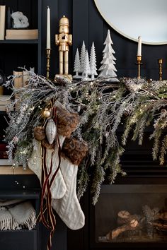 stockings hanging from a mantle with christmas decorations